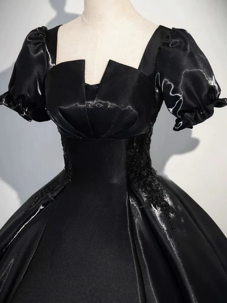 Model in A-line short sleeve satin black long evening dress, side view.
