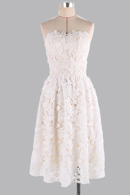 Front view of a woman wearing a champagne lace short prom dress.
