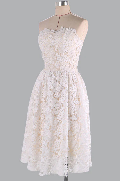 Side view of a woman wearing a champagne lace short homecoming dress.