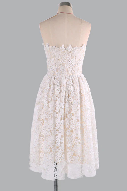 Back view of a woman wearing a champagne A-line sleeveless dress.