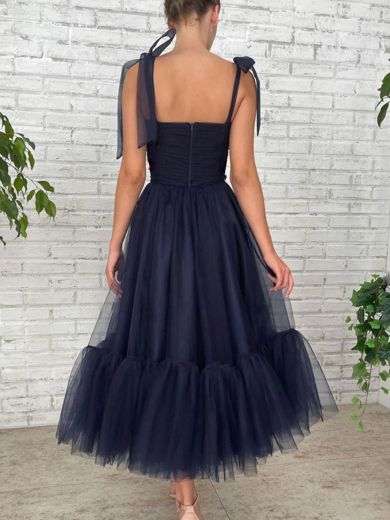 Side view of dark blue short bridesmaid dress, highlighting the fitted waist.