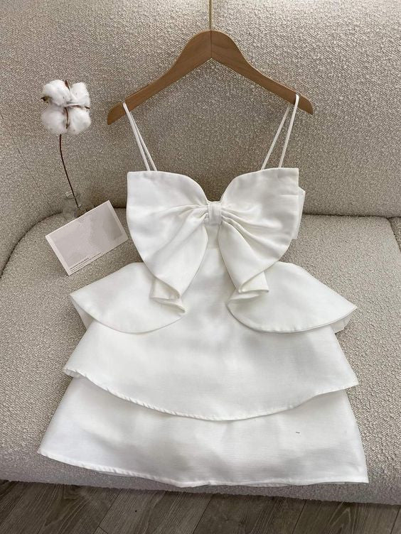 Woman in an elegant A-line mini homecoming dress, front view.