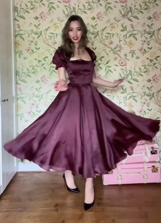 Side view of a pleated A-line blue party dress.