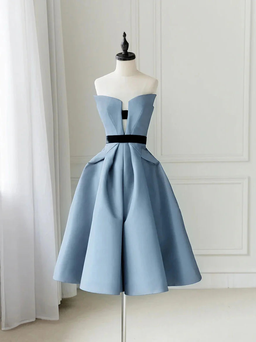 Woman wearing an elegant blue satin short prom dress with a flared skirt.