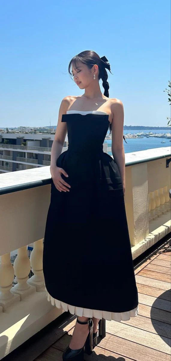 Back view of black A-line satin prom dress.
