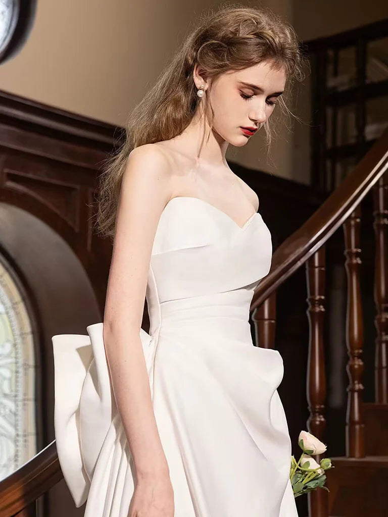 Close-up of the bodice and skirt of the white satin A-line gown.