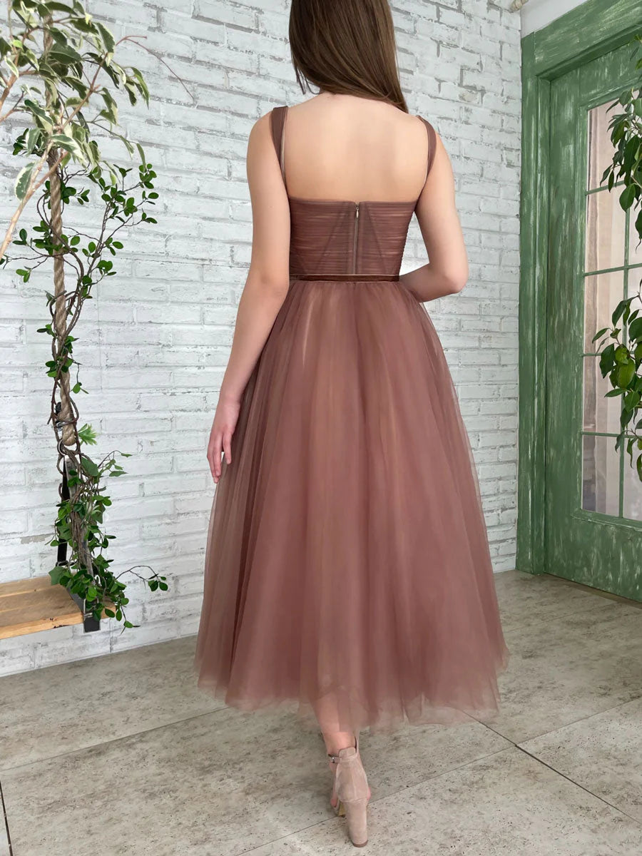 Side view of the simple brown tea-length homecoming dress.