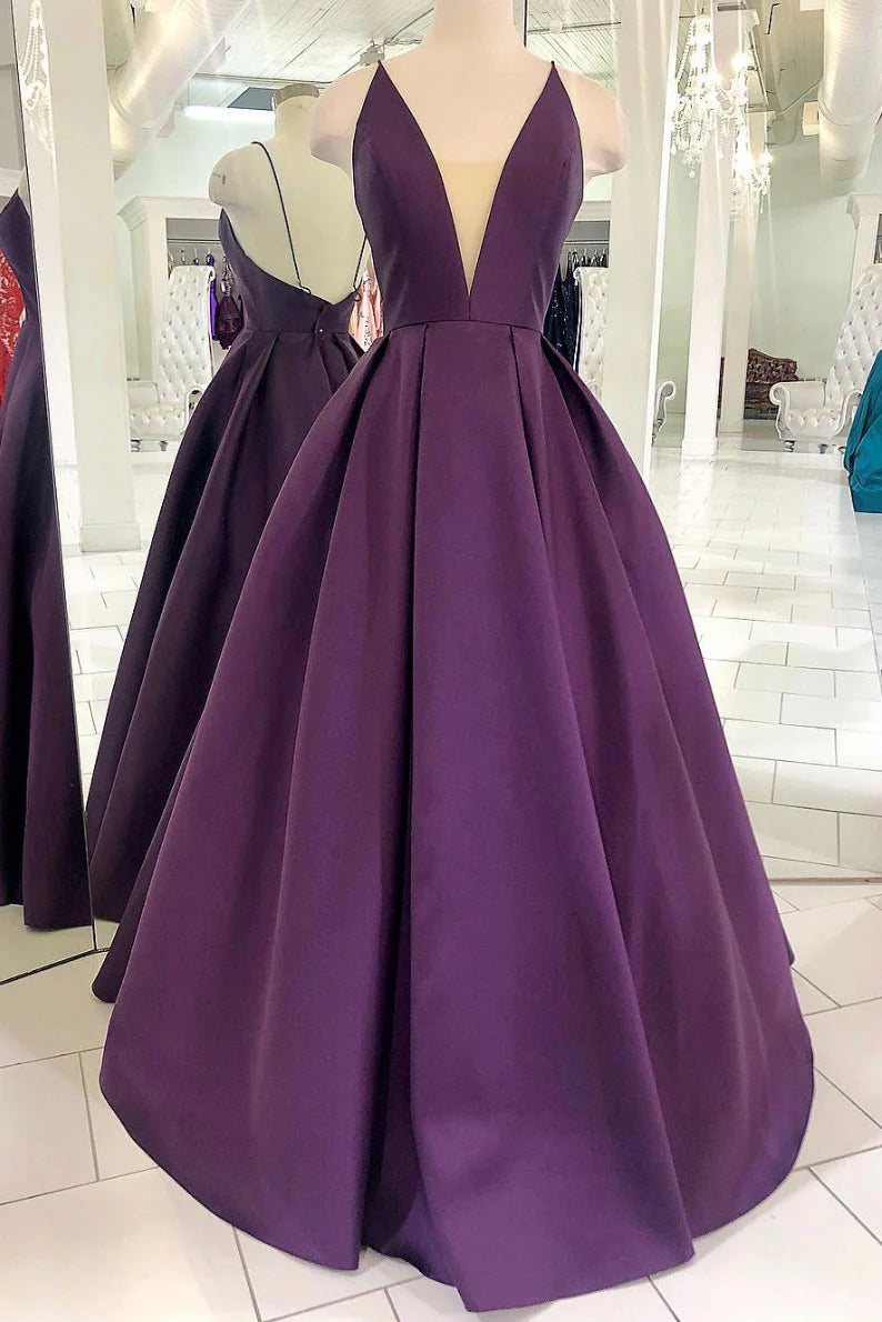 Woman wearing an elegant purple satin long prom dress.