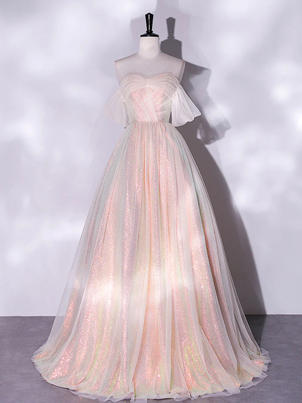 Front view of an elegant A-line pink tulle long prom dress.