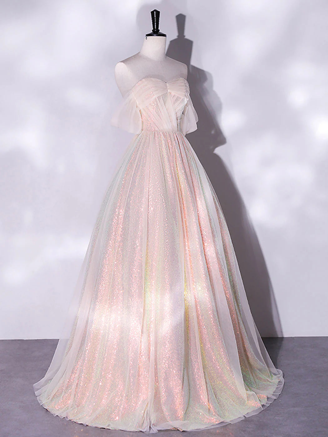 Side view of the flowy pink tulle A-line evening gown.