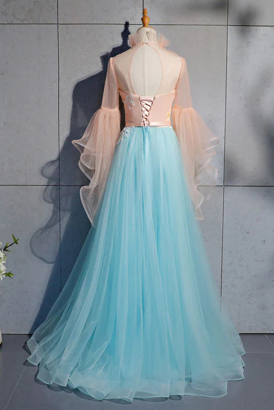 Back view of a woman in an elegant blue tulle lace evening gown.