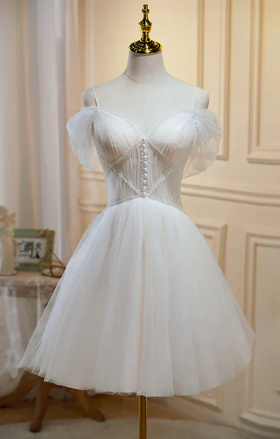 Model wearing an elegant short champagne tulle and lace prom dress.