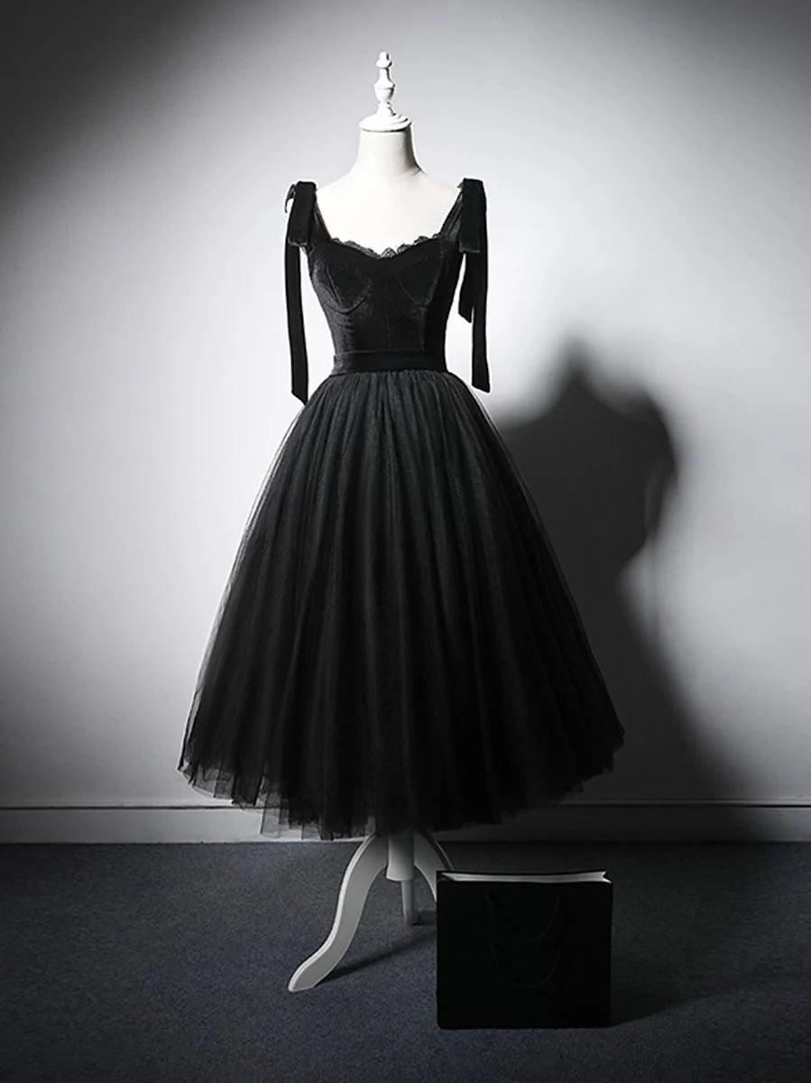 Front view of a woman wearing an elegant black tulle and lace short prom dress.