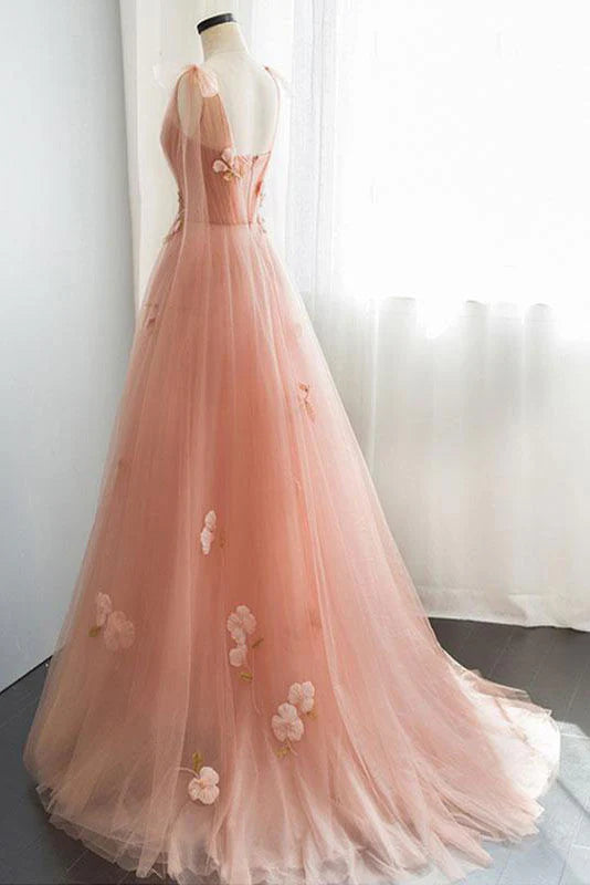 Side view of a flowing pink tulle evening gown.
