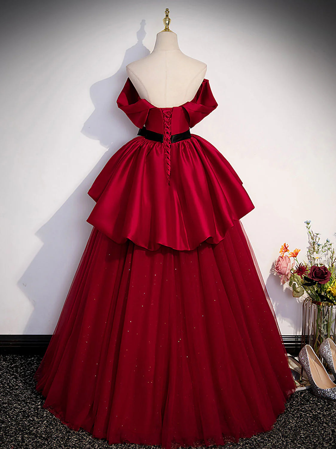 Model in elegant A-line burgundy satin long formal gown, back view.