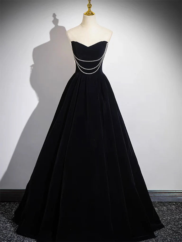 Back view of a model showcasing the elegant black velvet A-line gown.