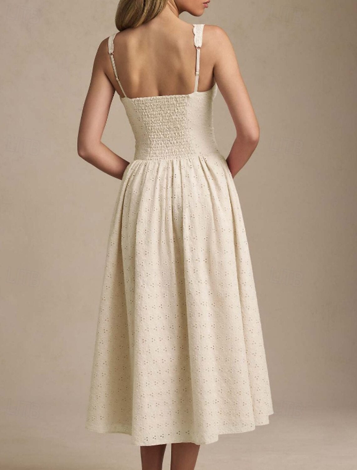 Detailed view of the white midi dress fabric and elegant design.