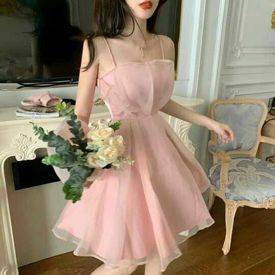 Model wearing a pink chiffon A-line short homecoming dress with slim shoulder straps.