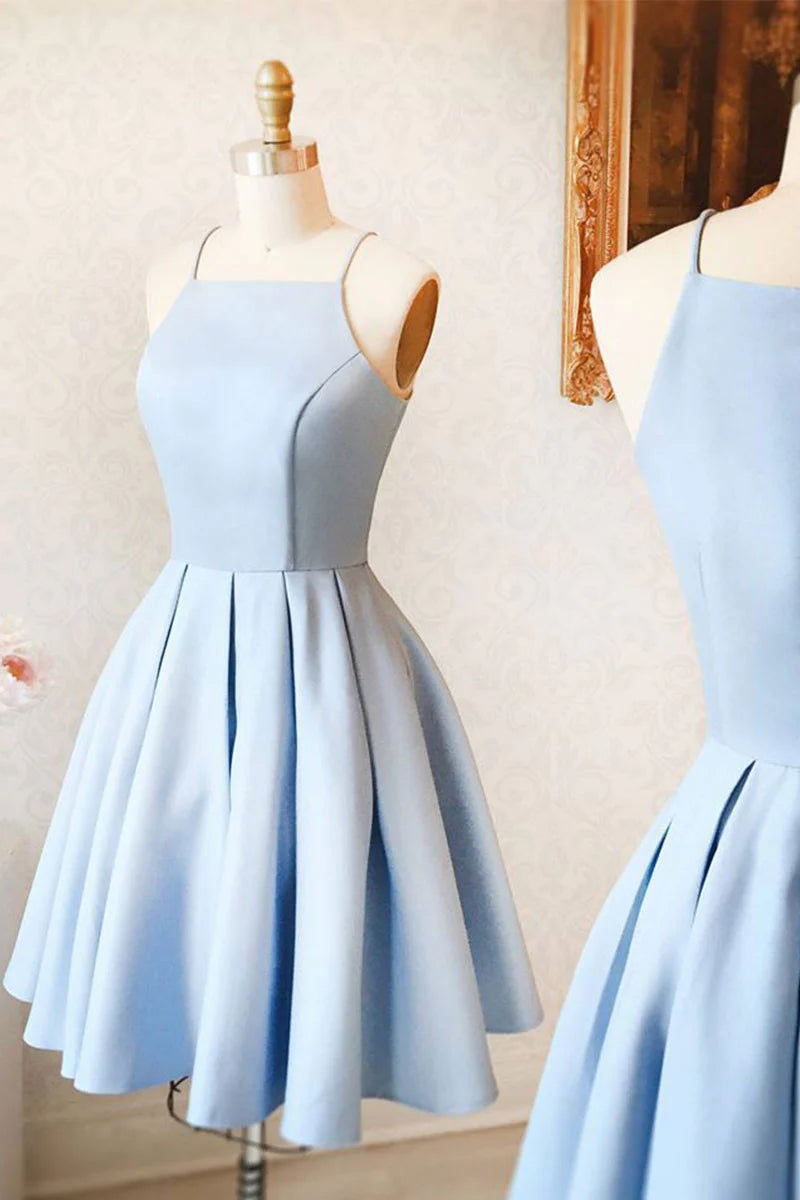 Woman wearing a blue short spaghetti strap A-line prom dress.