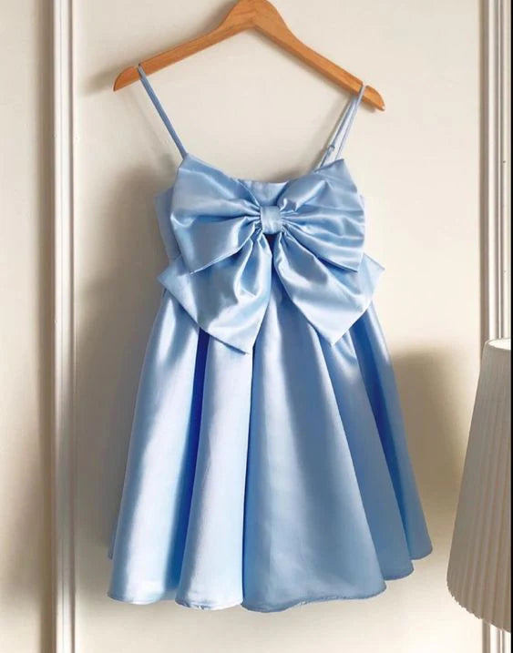 Light blue satin A-line short homecoming dress with spaghetti straps and a large back bow.