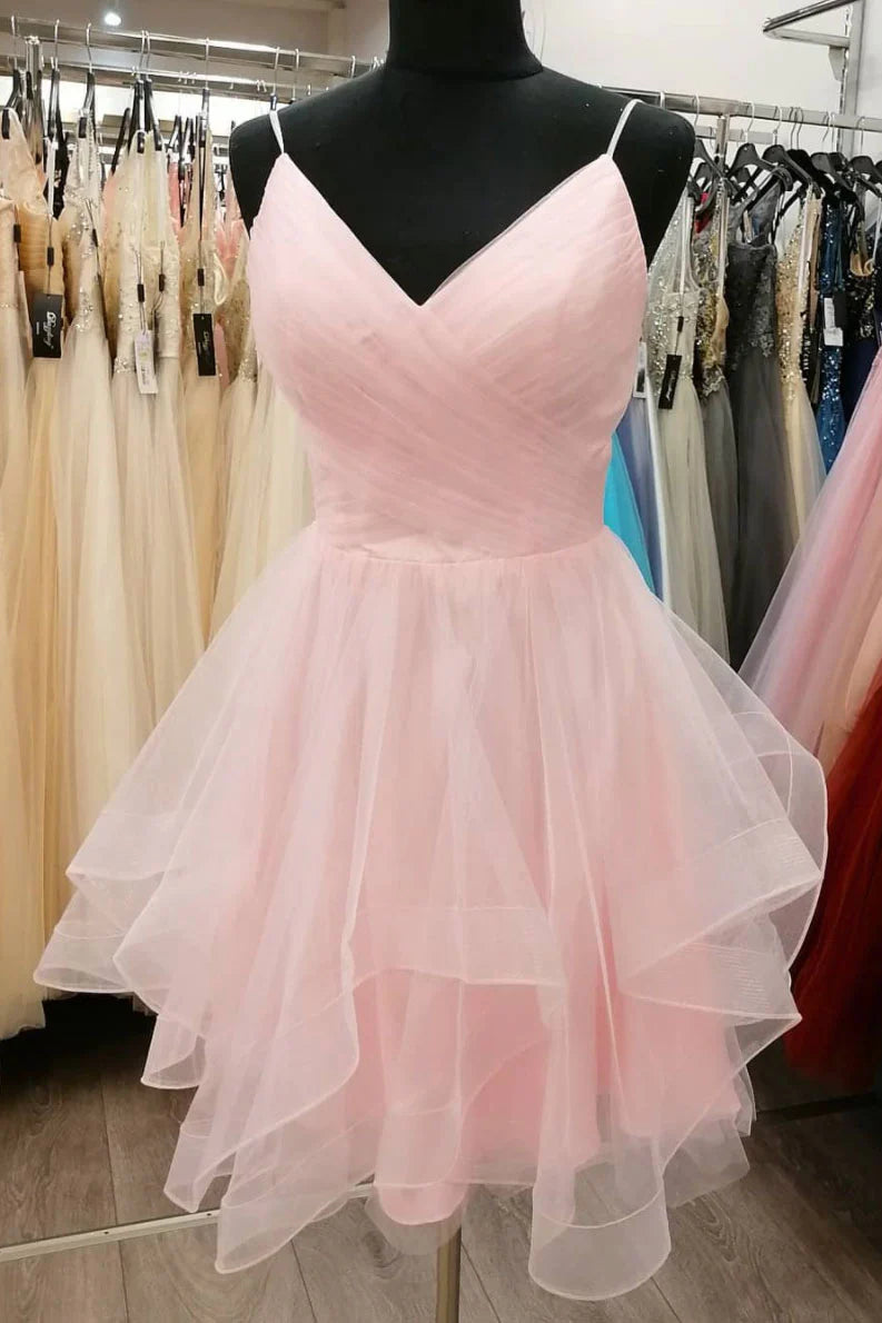 Model wearing a short pink tulle A-line dress with spaghetti straps.