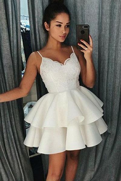 Elegant short satin dress with delicate lace details and spaghetti straps.