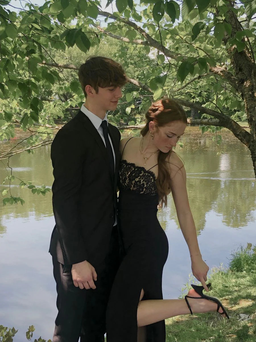 Black A-line prom dress with spaghetti straps and a high slit.