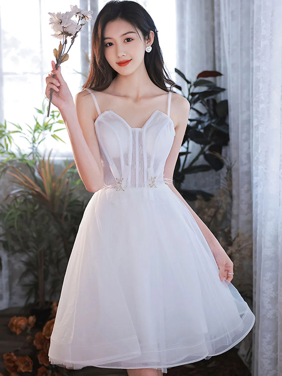 Back view of a model in a white spaghetti strap homecoming dress.