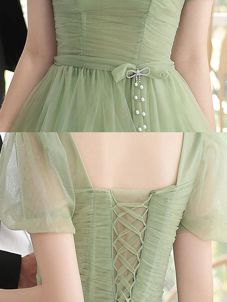 Side view of the green tulle A-line homecoming dress.