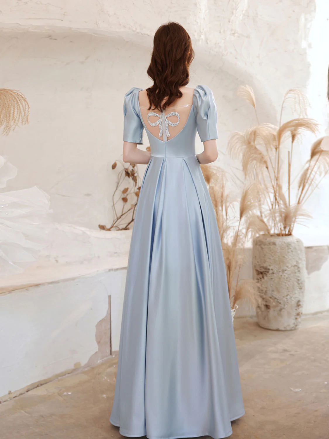 Side view of the flowing A-line satin blue formal evening dress.