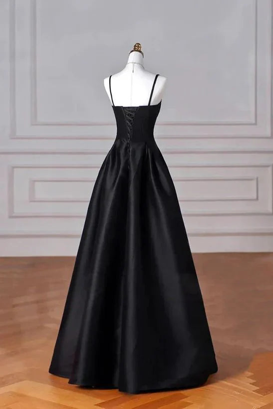 Side view of the black satin A-line long prom dress, showcasing its flowing silhouette.