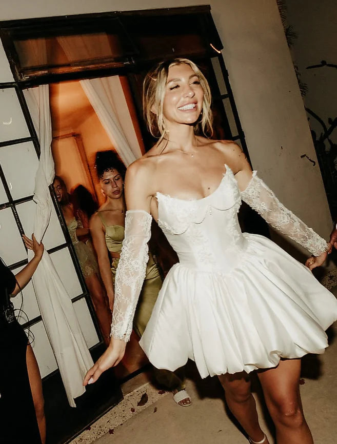 Back view of white satin short homecoming dress with pearl details.