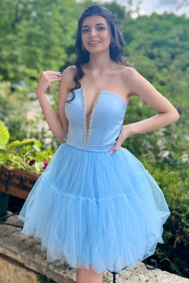 Model wearing a light blue strapless off-shoulder A-line homecoming dress with a plunge V-neck.