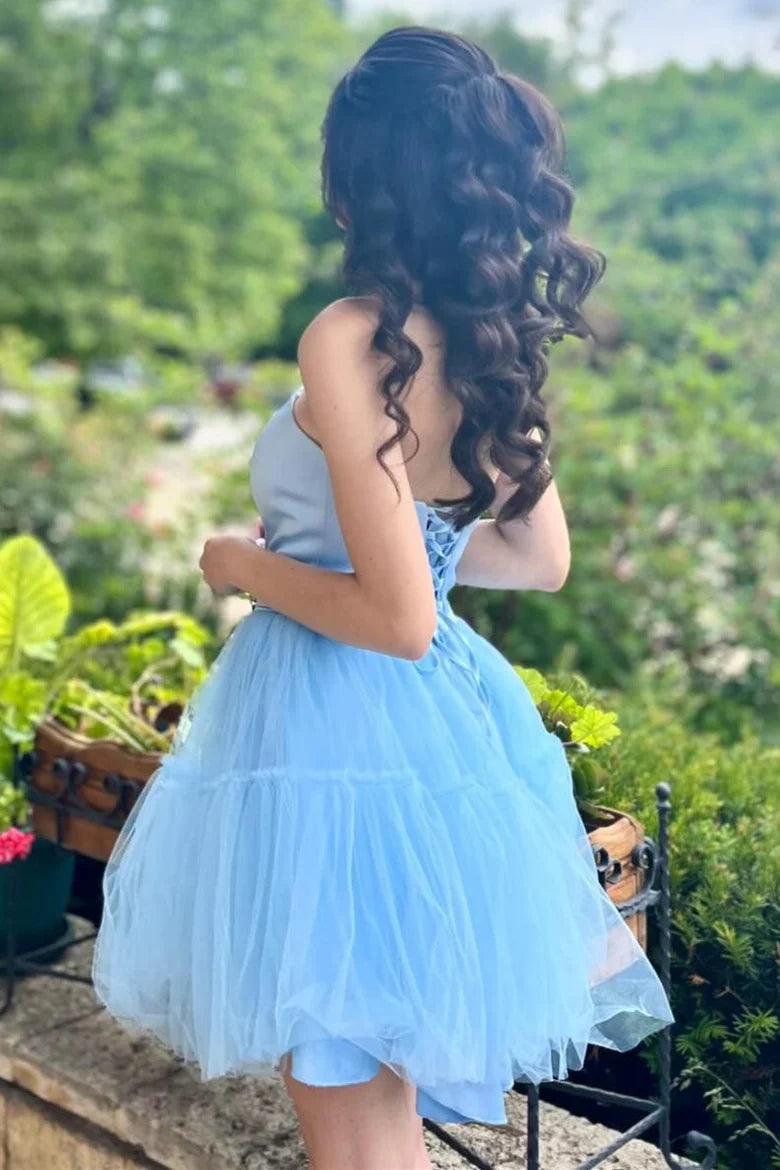 Back view of the light blue A-line homecoming dress, showcasing the elegant lace-up detail.