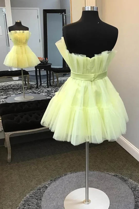 Side view of the light yellow A-line strapless off-shoulder tulle homecoming dress.
