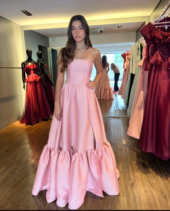 Woman wearing an elegant pink satin strapless A-line evening dress.