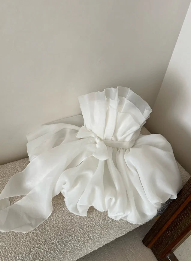 White A-line strapless short tulle dress with a large bow on the back.