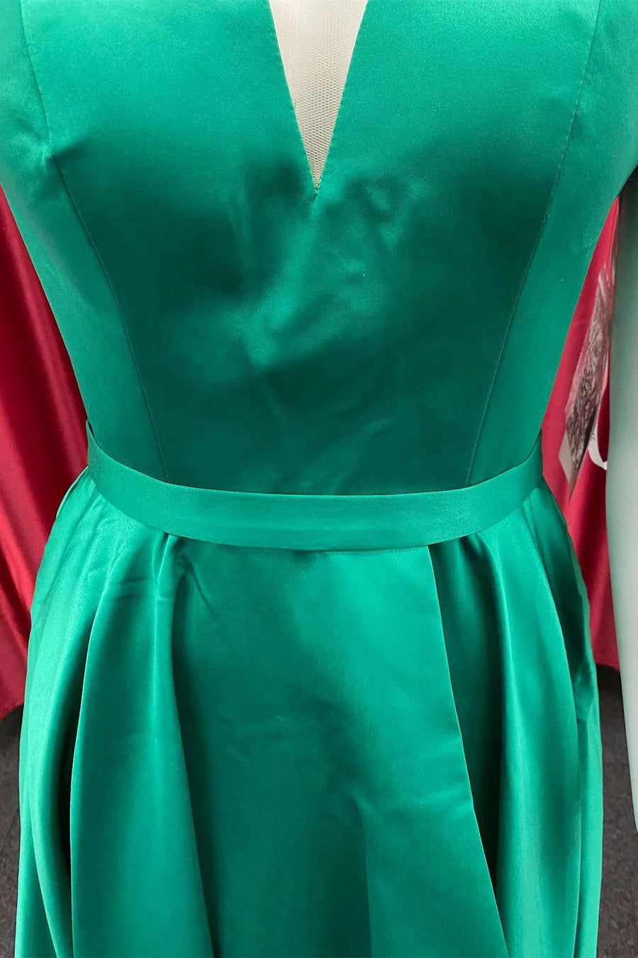 Model in a green A-line cold-shoulder homecoming dress, back view.