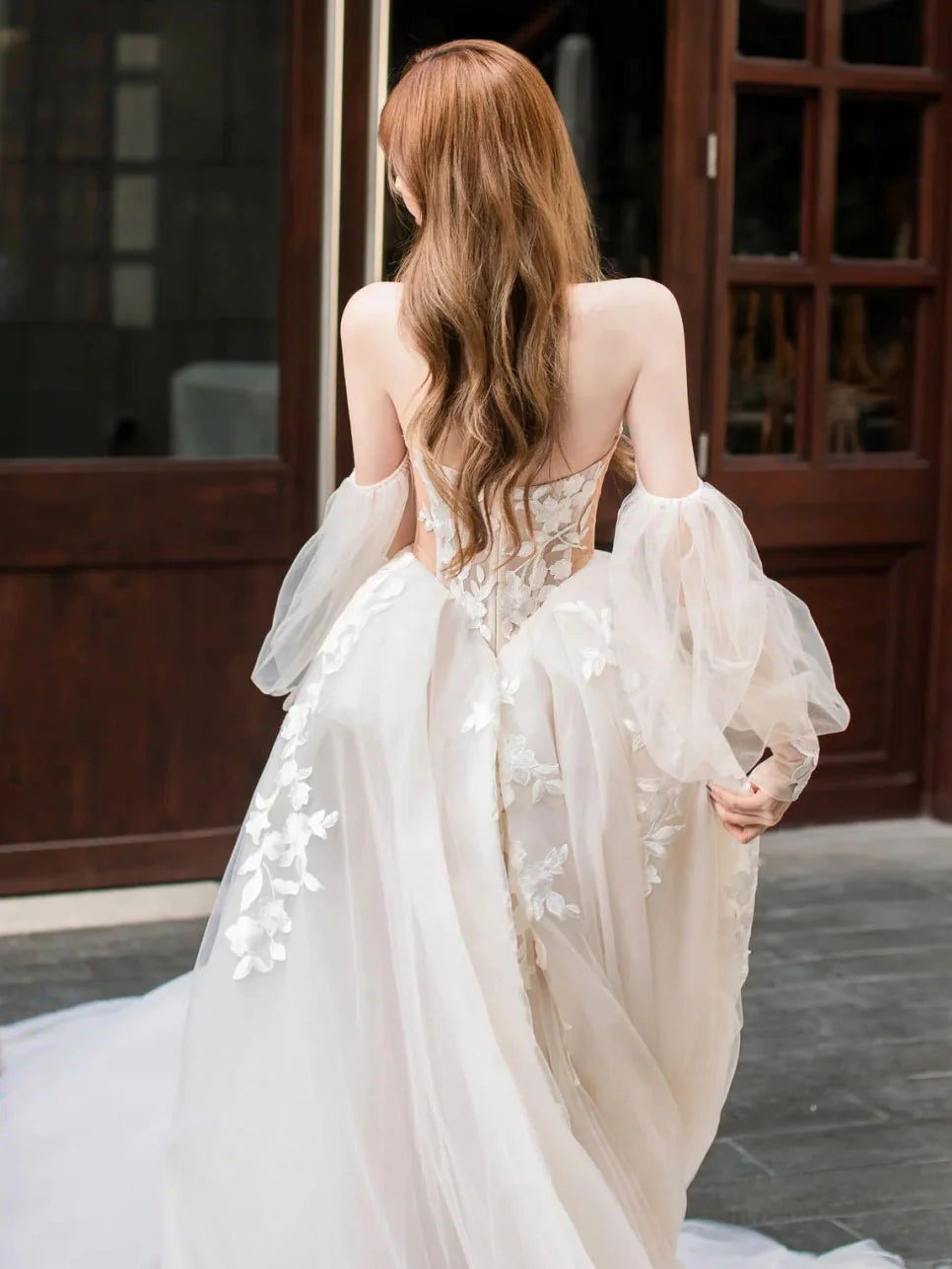 Light champagne A-line formal dress with lace bodice and flowing tulle skirt.