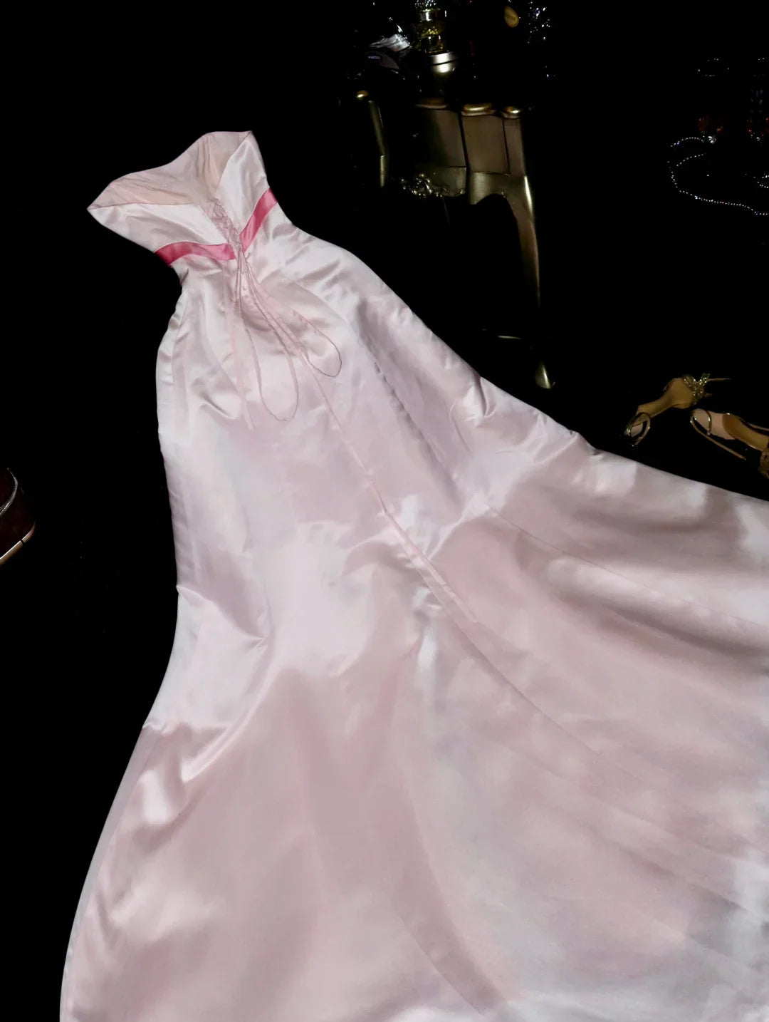 Model wearing a light pink A-line sweetheart neck satin long party dress with a bow detail.