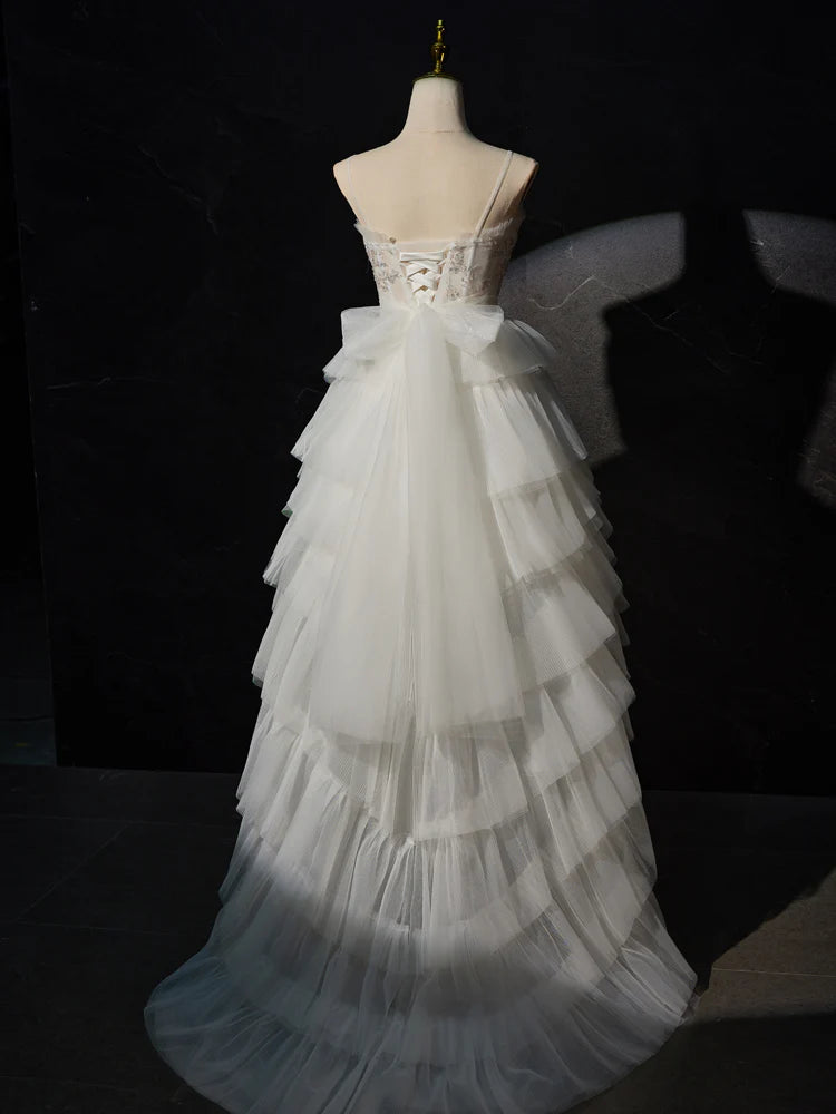Close-up of the white lace sweetheart neckline and flowing tulle skirt.