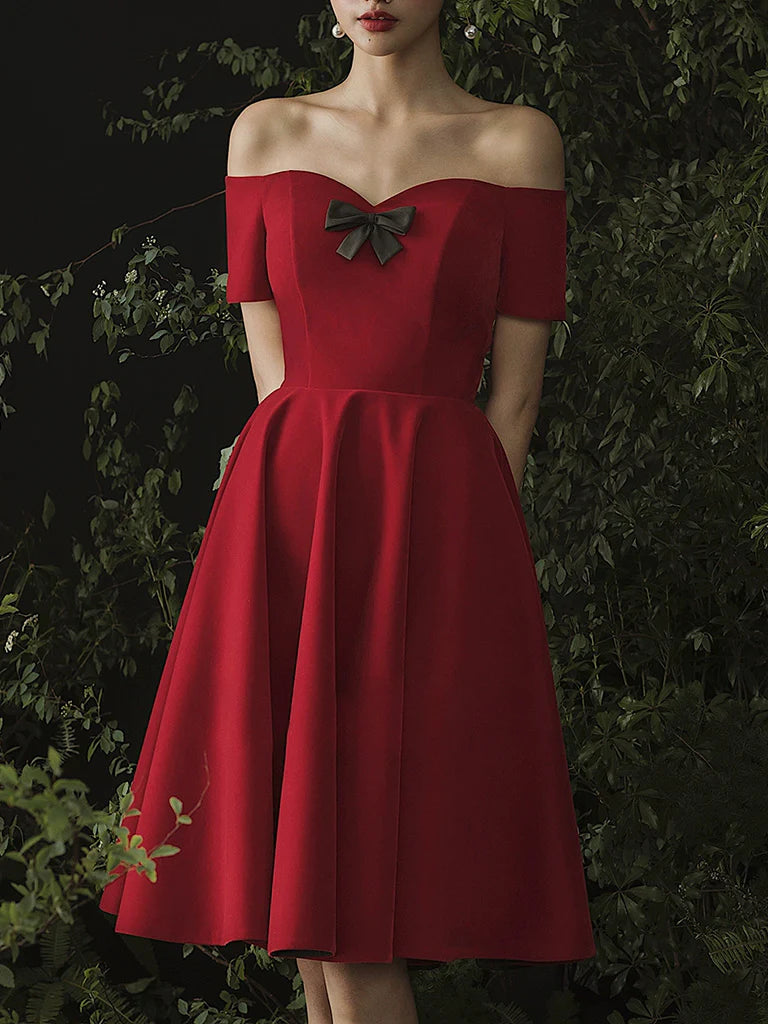 Front view of a woman wearing an elegant burgundy sweetheart neck short prom dress.