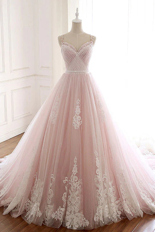 Side view of a flowing pink tulle evening gown.