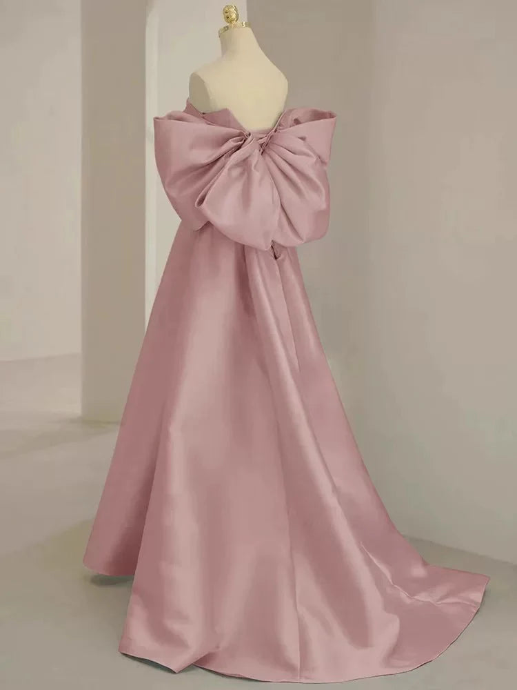 Side profile of the flowing A-line pink formal dress.