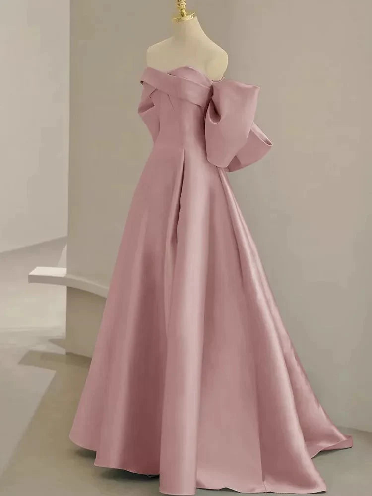 Close-up of the sweetheart neckline and satin fabric on the pink gown.