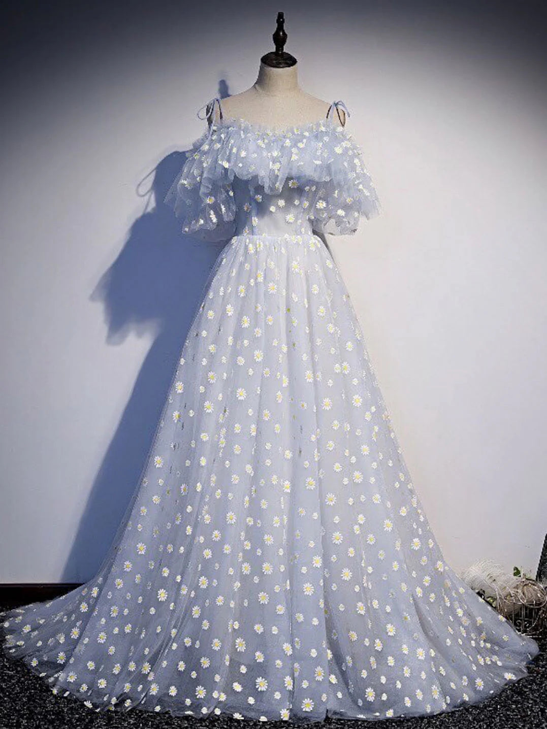 Model wearing an elegant blue sweetheart neck tulle long prom dress with a cinched waist.