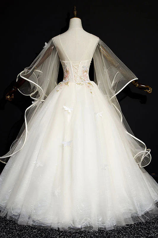 Close-up of the intricate tulle and lace detailing on the light champagne formal gown.