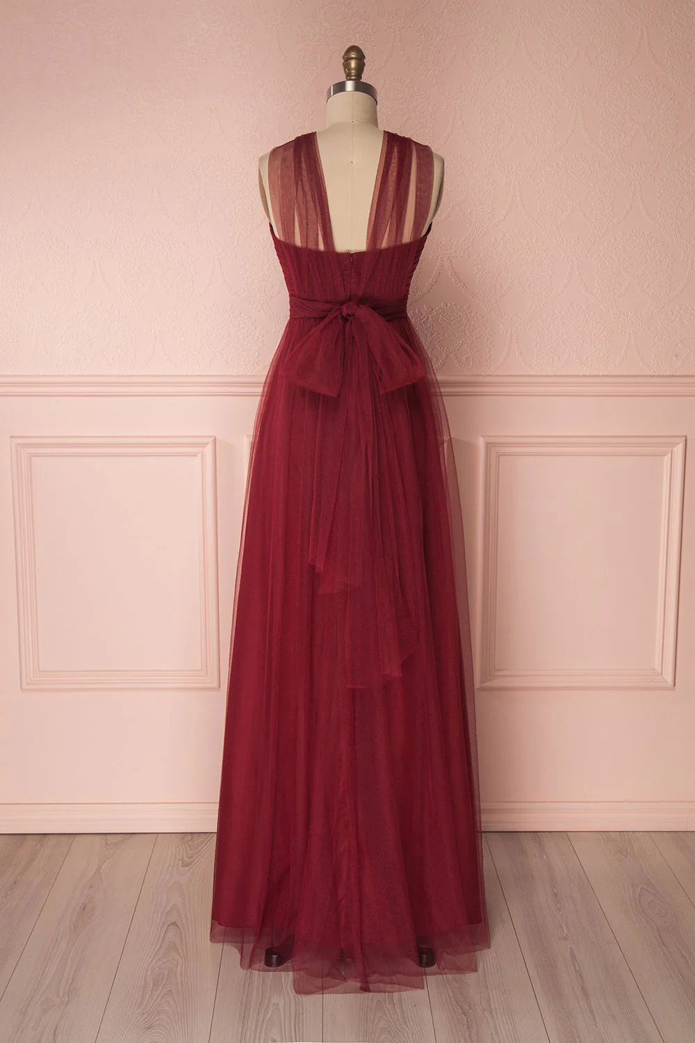 Side view of the elegant burgundy evening gown, showing waist detail.