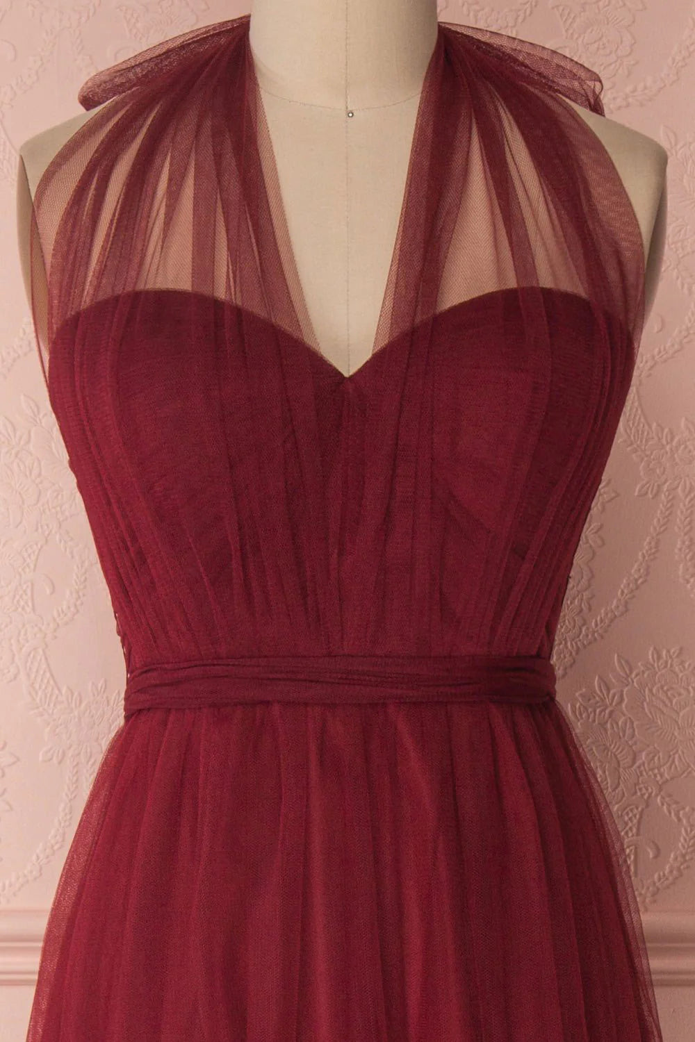 Back view of the burgundy tulle formal dress, highlighting the flowing skirt.