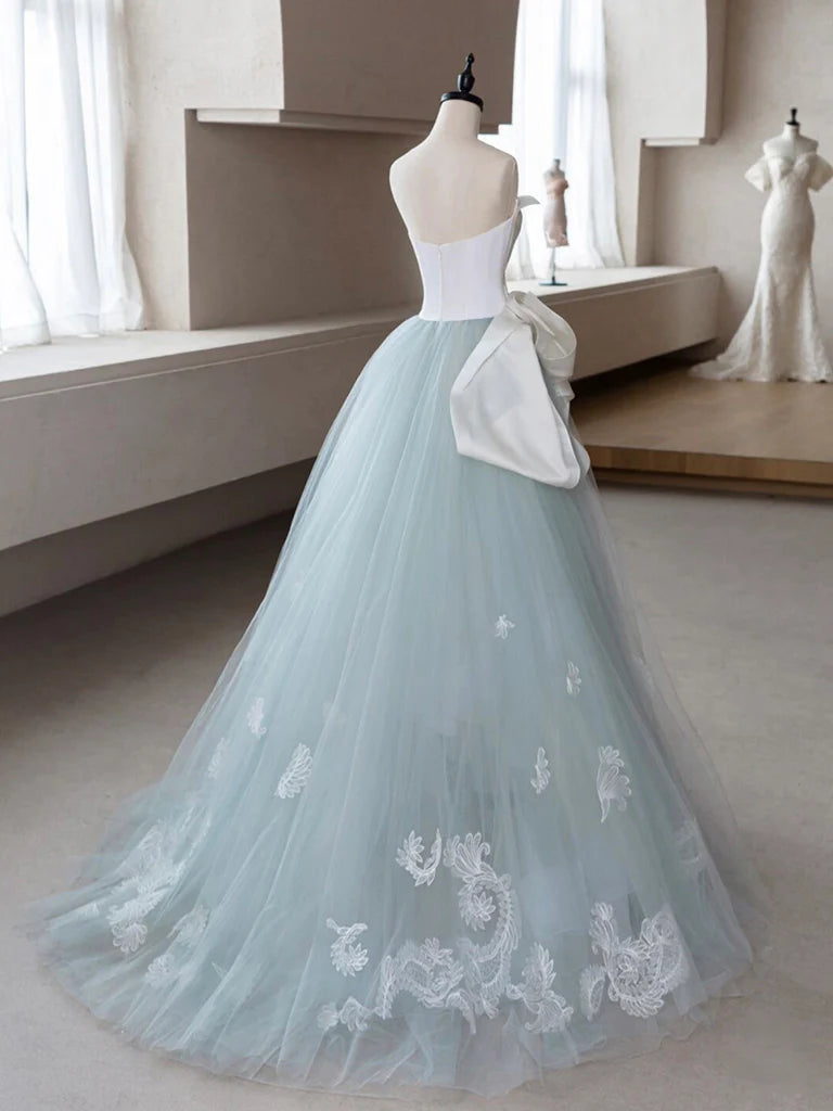 A-line blue tulle lace formal dress, side view showing flowing skirt.